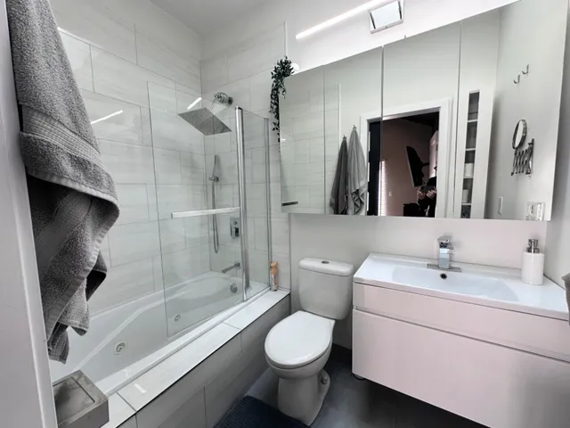 a bathroom with a sink toilet and shower