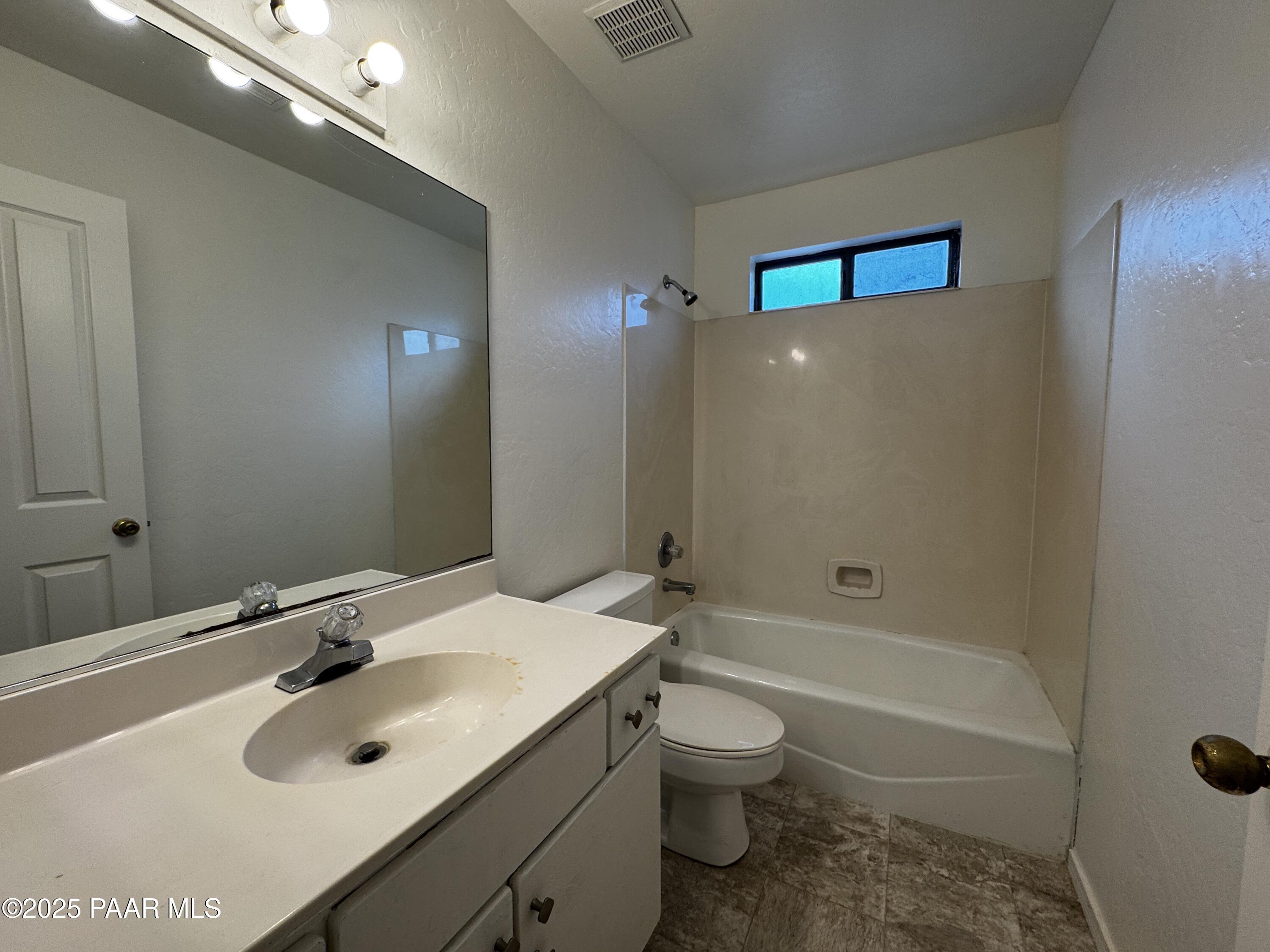 719 Bird Street, Unit B Prescott, AZ 86301 - Photo 11 of 12 a bathroom with a sink a toilet and shower