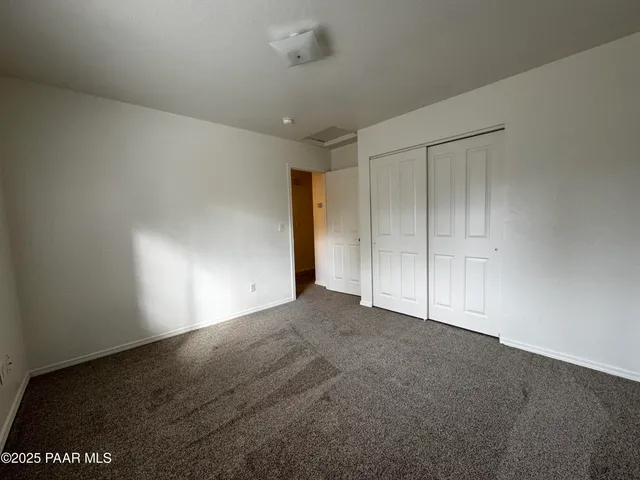a view of an empty room and a window