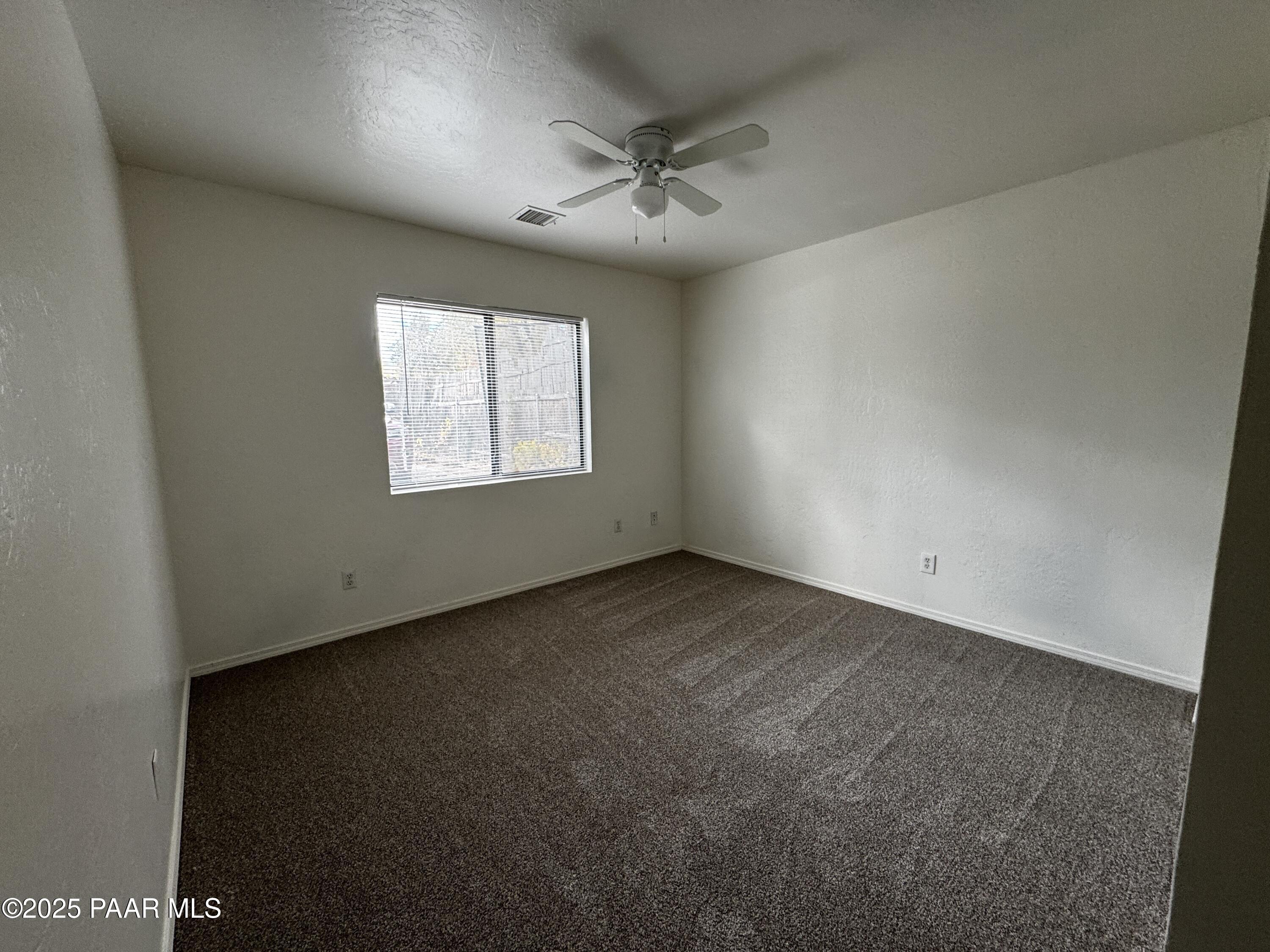 719 Bird Street, Unit B Prescott, AZ 86301 - Photo 6 of 12 an empty room with a window