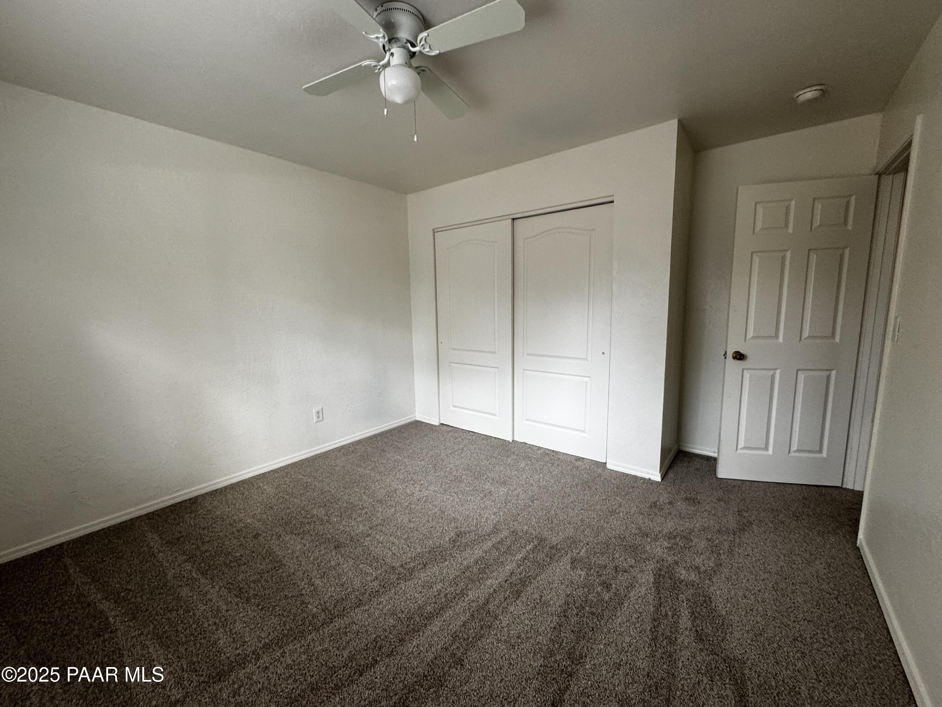 719 Bird Street, Unit B Prescott, AZ 86301 - Photo 7 of 12 a view of an empty room and chandelier fan