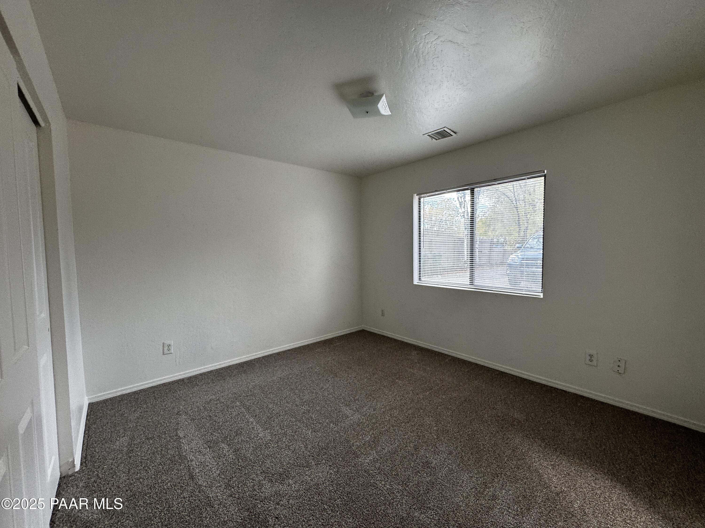 719 Bird Street, Unit B Prescott, AZ 86301 - Photo 10 of 12 an empty room with a window
