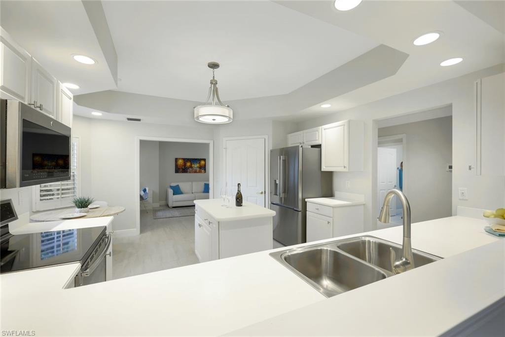 6240 Reserve Circle, Unit 802 Naples, FL 34119 - Photo 14 of 47 Open view from kitchen to Livingroom.