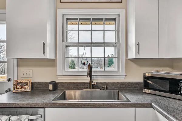 a kitchen with granite countertop a sink and a window