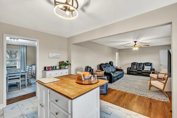 a kitchen with a stove a refrigerator and dining table