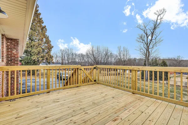 a view of balcony with wooden floor and fence
