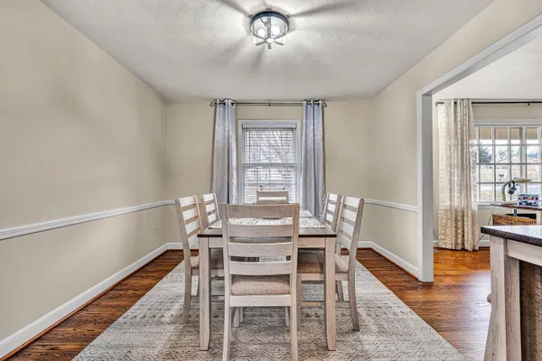 a view of a dining room with furniture wooden floor and chandelier