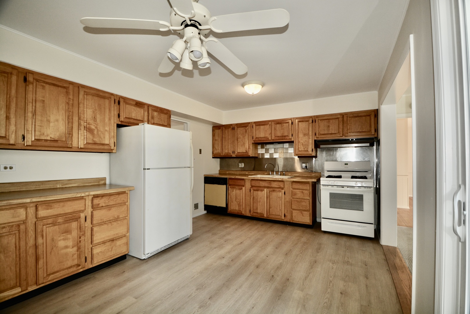 609 North Loomis Street Naperville, IL 60563 - Photo 3 of 13 a kitchen with refrigerator cabinets and wooden floor