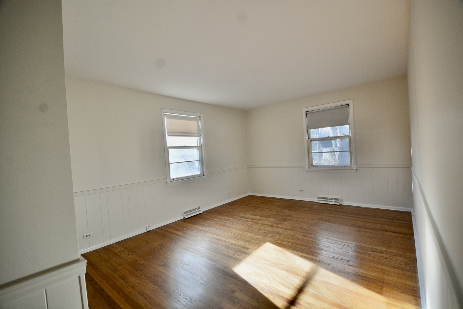 609 North Loomis Street Naperville, IL 60563 - Photo 7 of 13 an empty room with wooden floor and windows