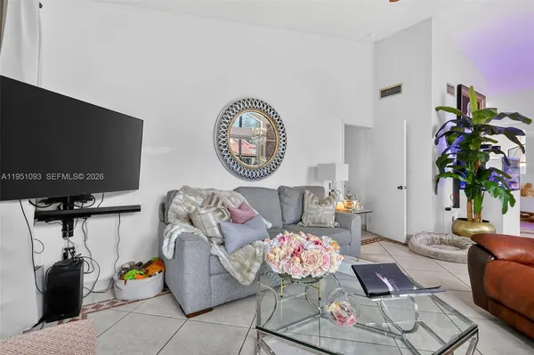 a living room with furniture and a large window