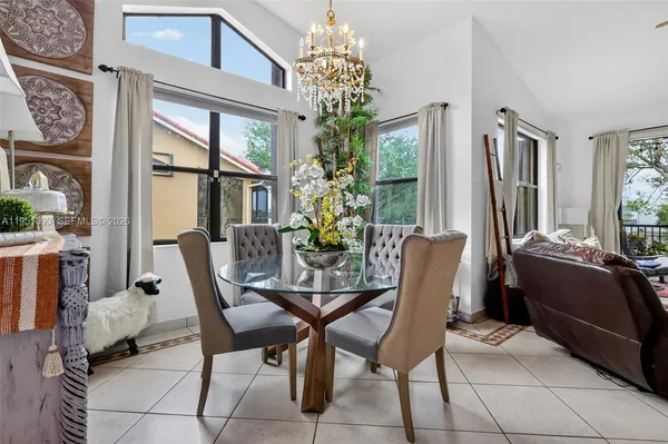 a living room with furniture a chandelier and a window