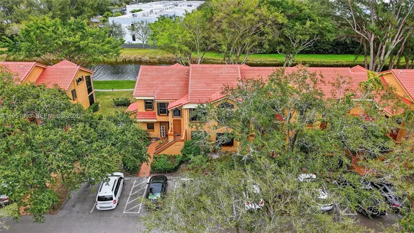 an aerial view of a house with a yard basket ball court and outdoor seating