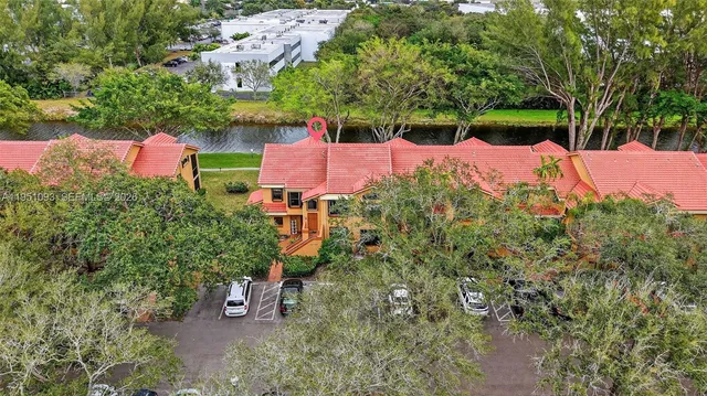 an aerial view of a house with outdoor space and lake view