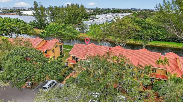 an aerial view of a house with outdoor space and tennis court