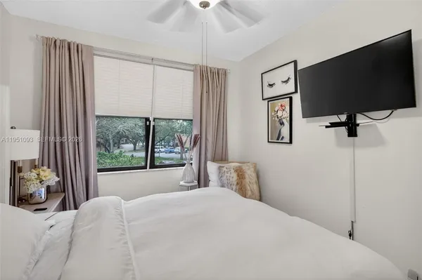 a bedroom with a large bed and a chandelier