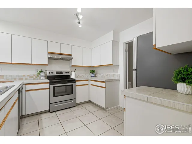 a kitchen with a stove a sink and a refrigerator