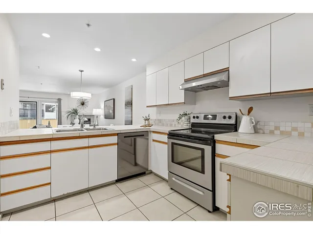 a kitchen with stainless steel appliances granite countertop a sink and cabinets