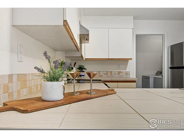 a view of kitchen with furniture and refrigerator