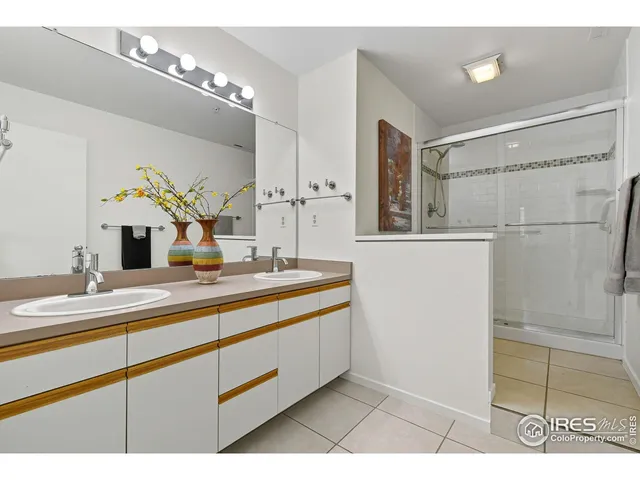 a bathroom with a sink a mirror and a shower