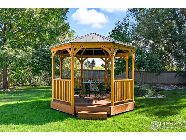 a view of a wooden deck with a yard