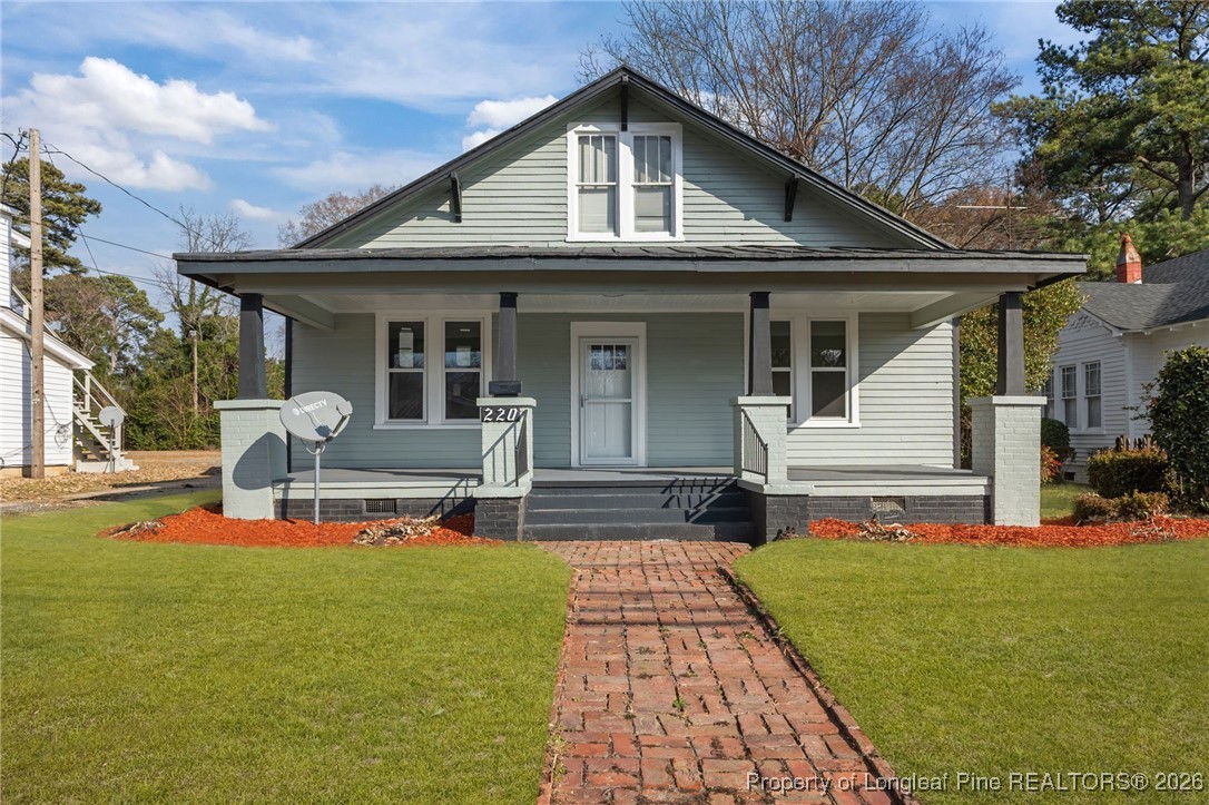 220 Beaman Street Clinton, NC 28328 - Photo 1 of 32 a front view of house with outdoor seating