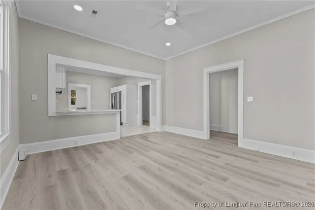 wooden floor in an empty room with a window