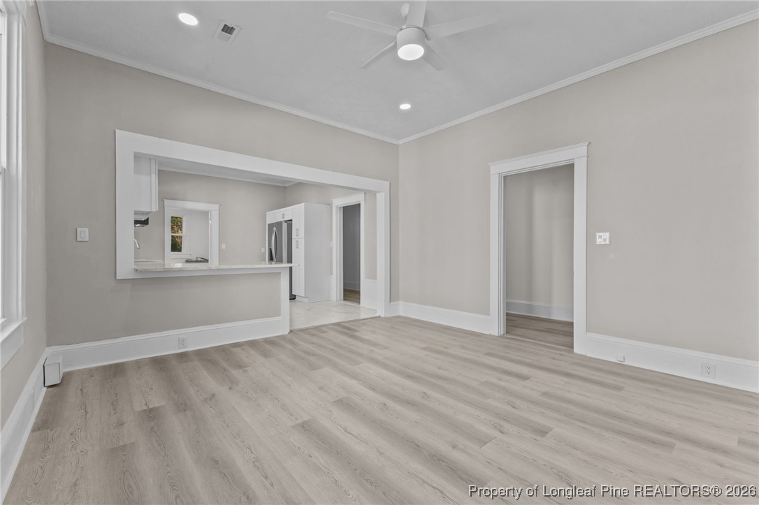 220 Beaman Street Clinton, NC 28328 - Photo 11 of 32 wooden floor in an empty room with a window