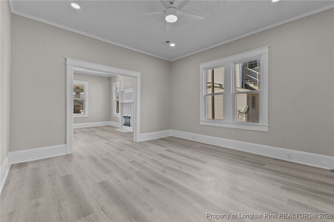 220 Beaman Street Clinton, NC 28328 - Photo 13 of 32 a view of empty room with wooden floor and fan