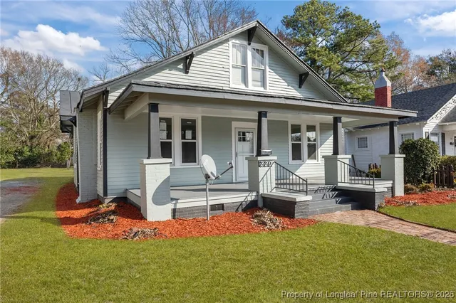 a front view of house with a garden and sitting area