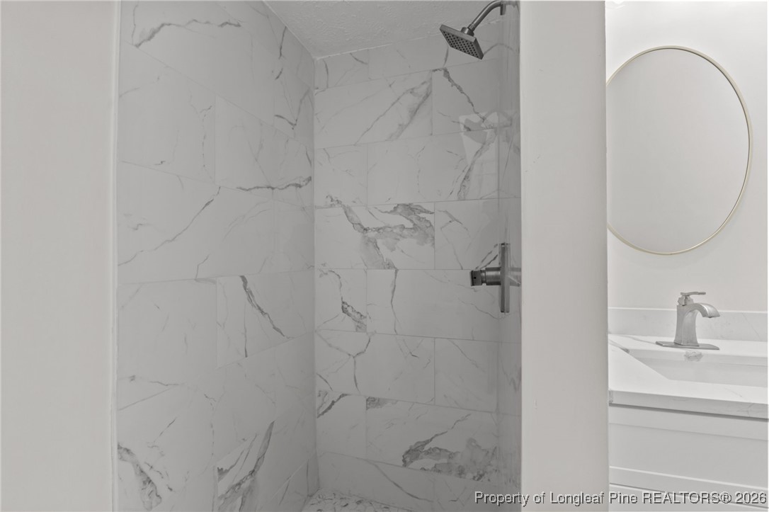 220 Beaman Street Clinton, NC 28328 - Photo 25 of 32 a bathroom with a sink and vanity