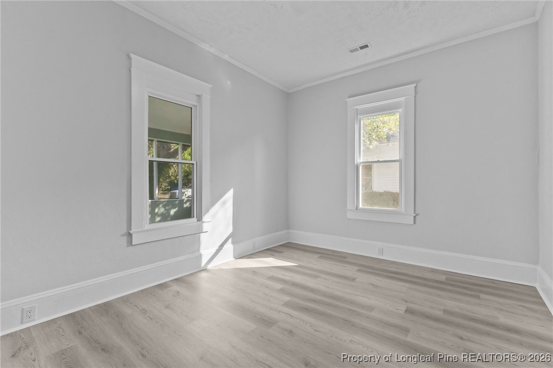 220 Beaman Street Clinton, NC 28328 - Photo 26 of 32 an empty room with windows and closet