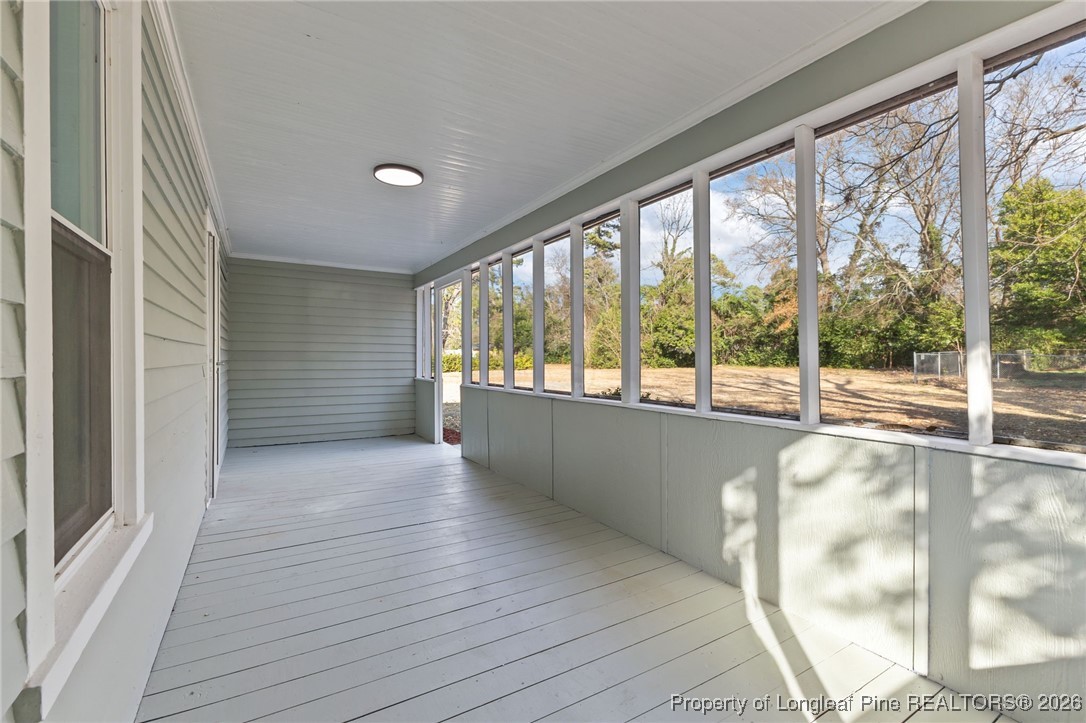 220 Beaman Street Clinton, NC 28328 - Photo 29 of 32 a view of an empty room with wooden floor and a window