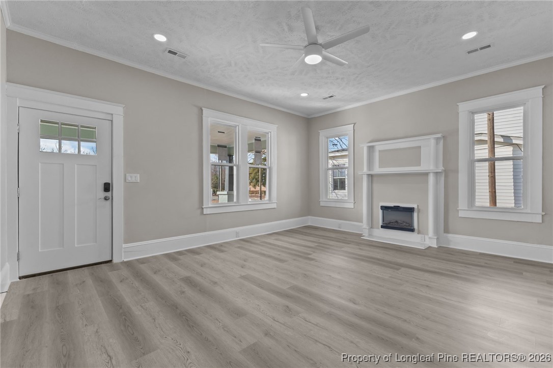 220 Beaman Street Clinton, NC 28328 - Photo 4 of 32 an empty room with windows and fireplace