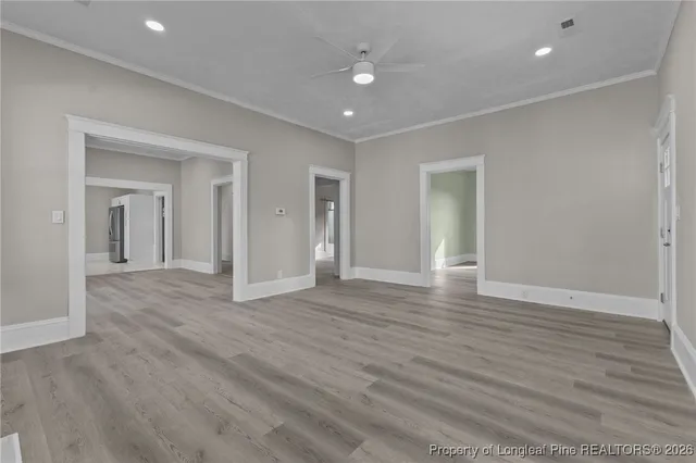 a view of empty room with wooden floor