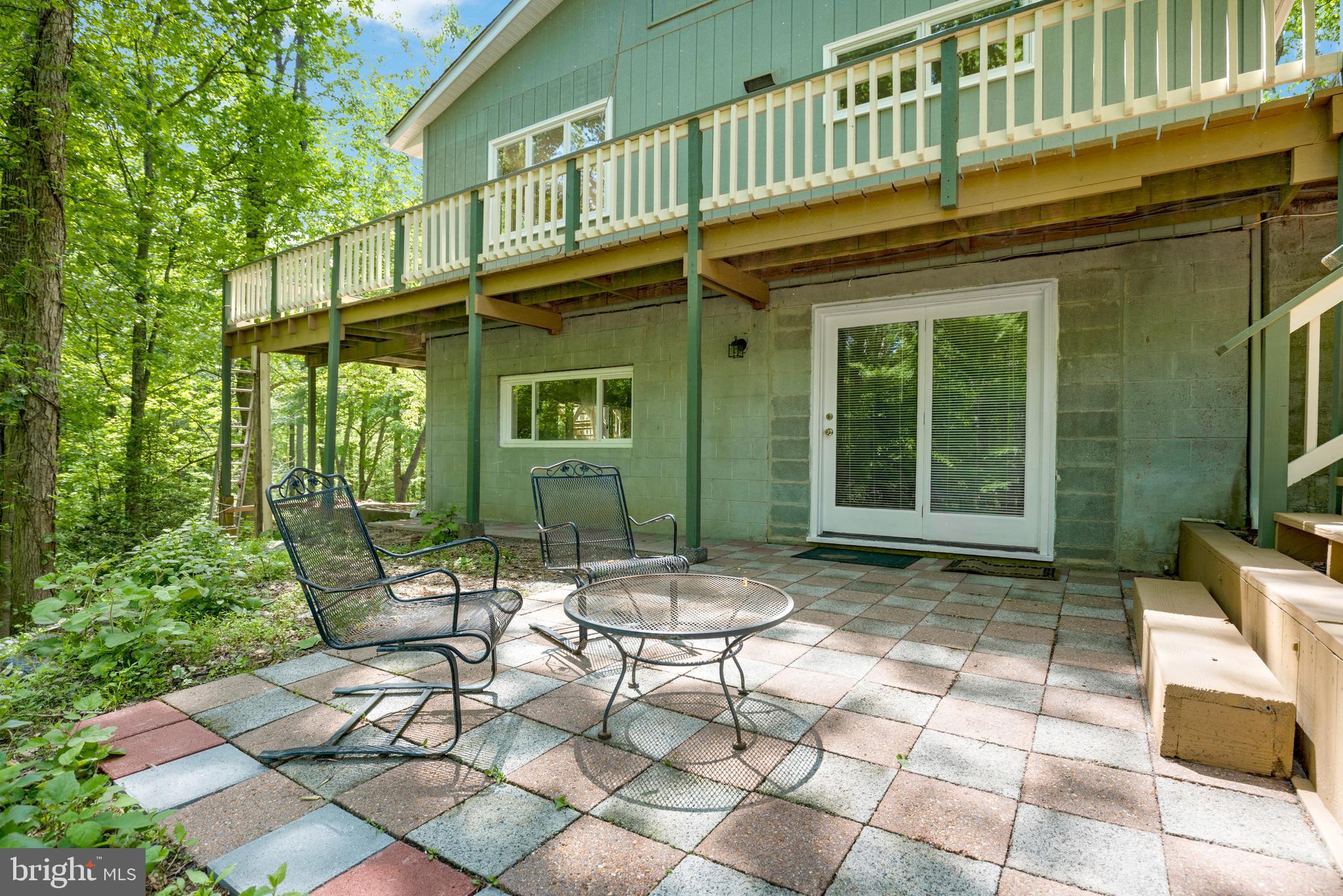 11425 Mill Bridge Road Lusby, MD 20657 - Photo 24 of 40 a view of a chairs and table in backyard of the house