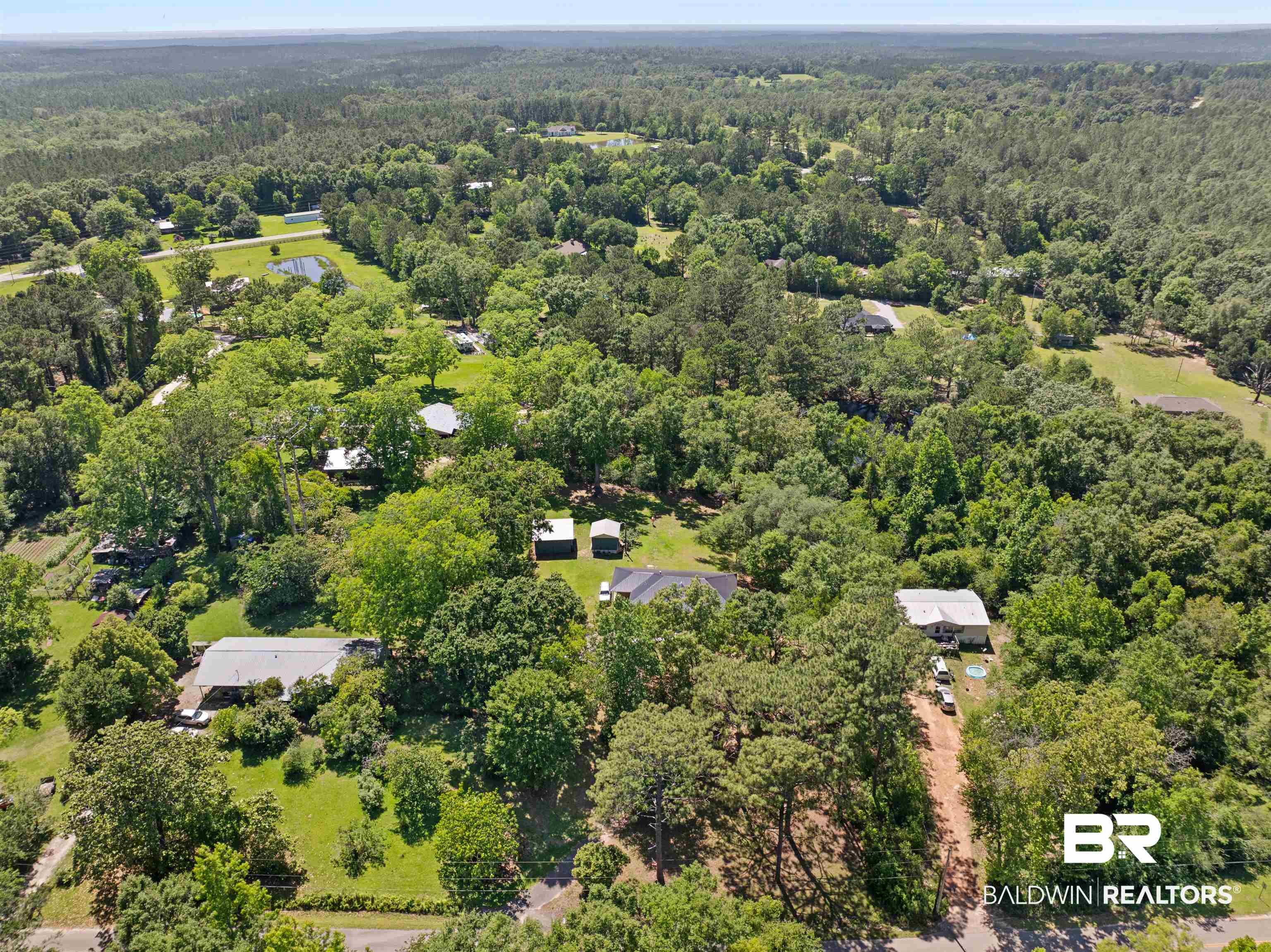 35893 Pine Road South Stapleton, AL 36578 - Photo 29 of 31 Aerial perspective showcasing a residential property surrounded by mature trees