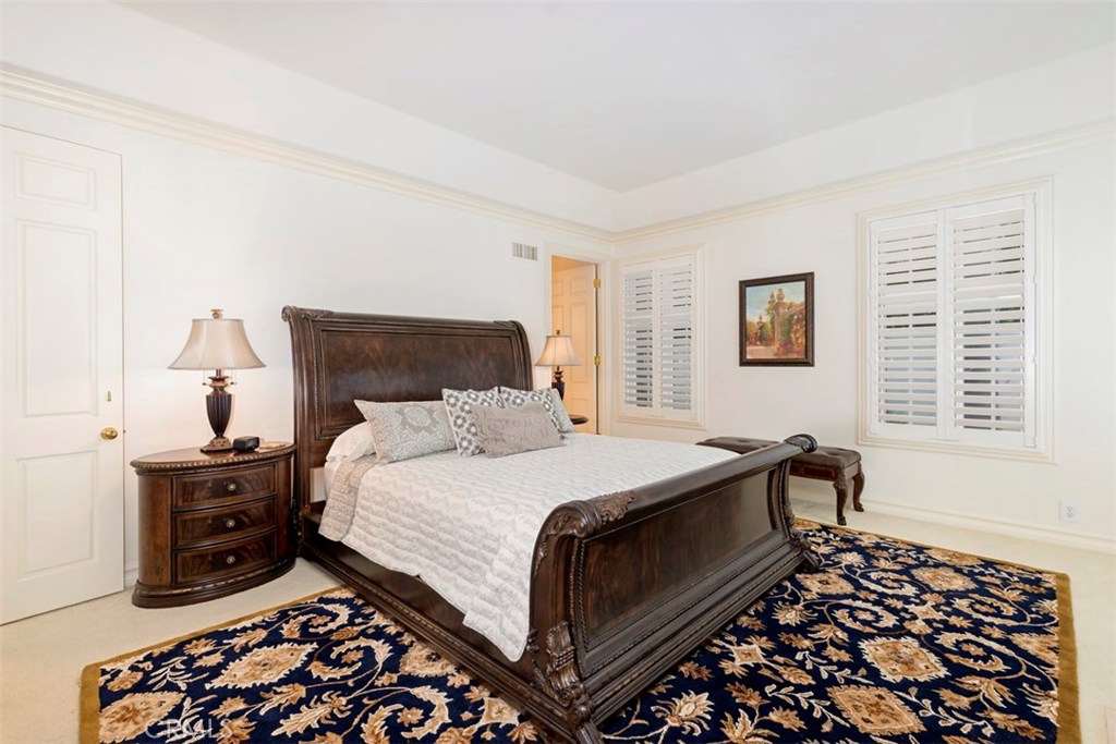 97 Ritz Cove Drive Dana Point, CA 92629 - Photo 17 of 43 a bedroom with a bed and wooden floor