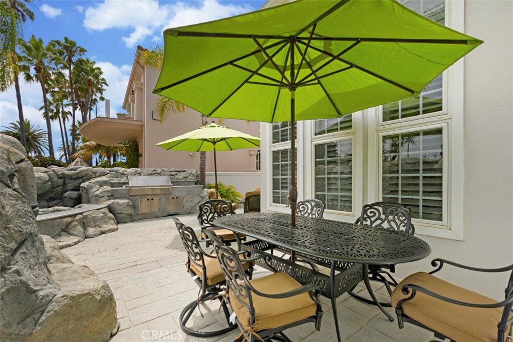 97 Ritz Cove Drive Dana Point, CA 92629 - Photo 31 of 43 a table and chairs under an umbrella