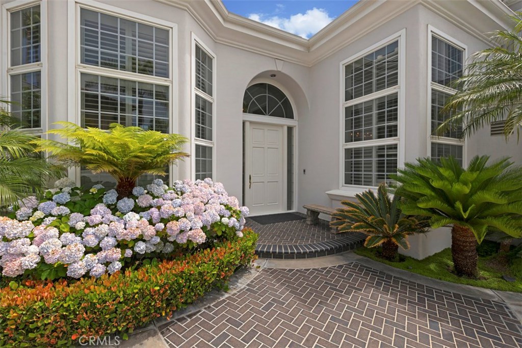 97 Ritz Cove Drive Dana Point, CA 92629 - Photo 4 of 43 a front view of a house with a yard and flowers