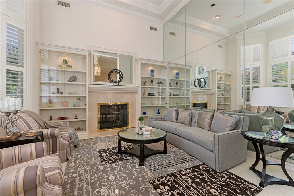 97 Ritz Cove Drive Dana Point, CA 92629 - Photo 7 of 43 a living room with furniture a rug a fireplace and a window