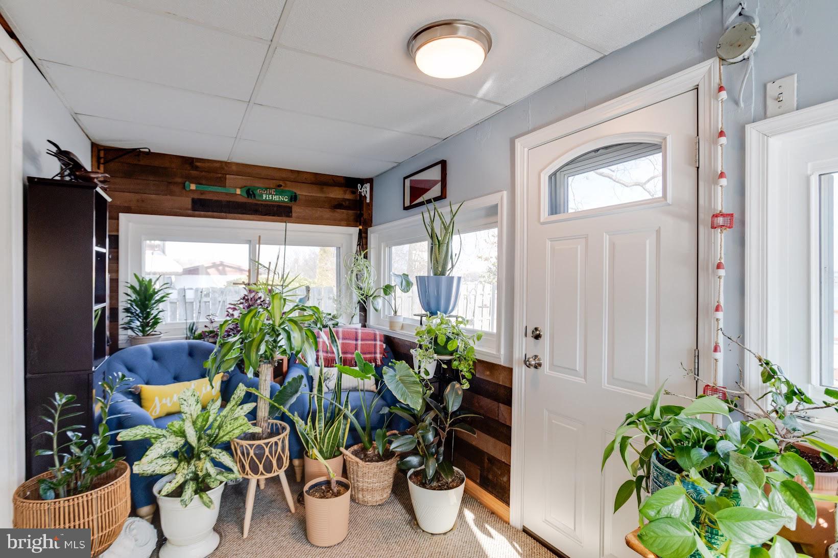 215 Nanticoke Road Essex, MD 21221 - Photo 17 of 28 Lush greenery brightens a cozy sunroom.