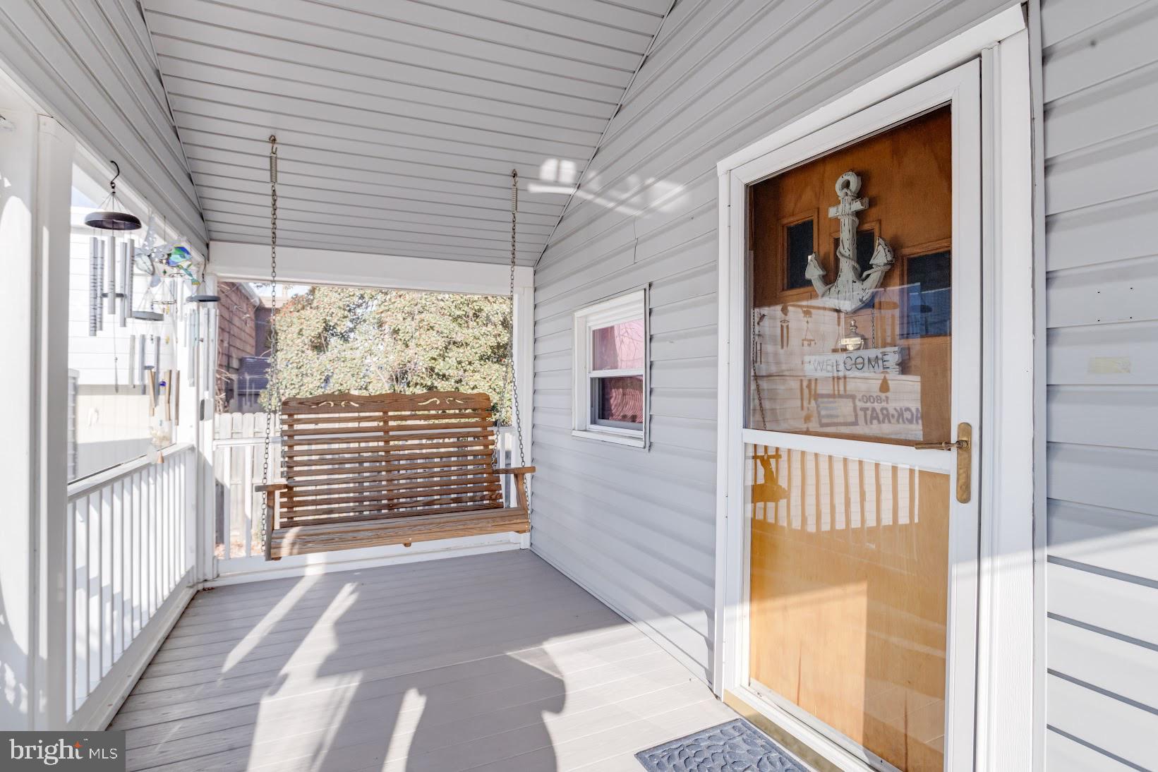 215 Nanticoke Road Essex, MD 21221 - Photo 5 of 28 Charming porch with a welcoming swing.