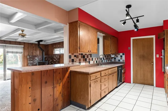a view of an empty room with a fireplace and a window
