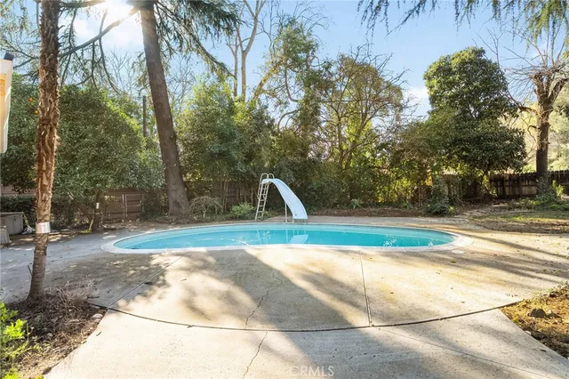 a view of a room with wooden floor and a bathroom