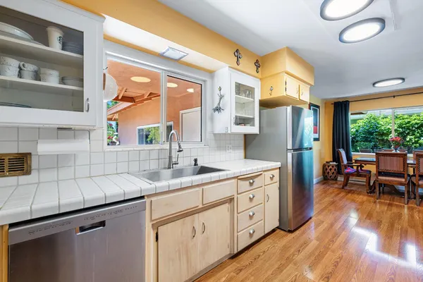a kitchen with sink cabinets and wooden floor