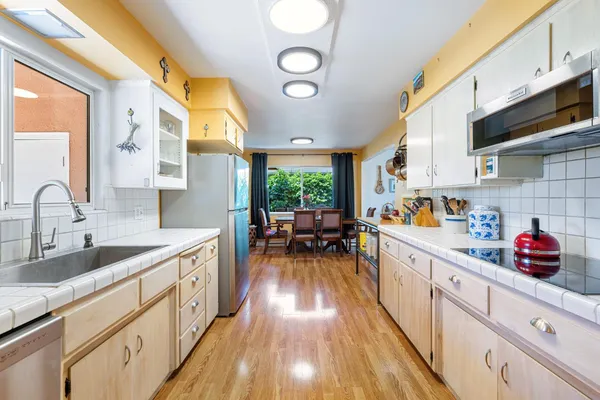 a kitchen with lots of counter top space and wooden floor