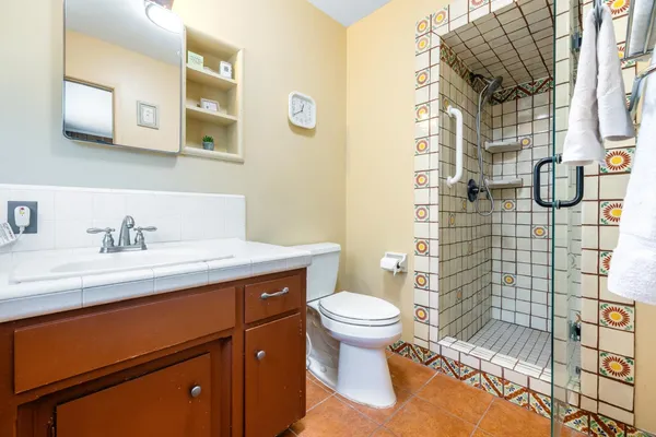 a bathroom with a sink toilet and shower