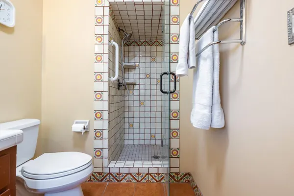 a bathroom with a toilet and shower