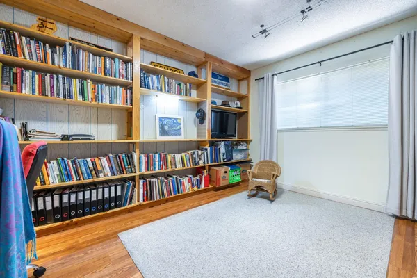 a room with lots of books and a large window