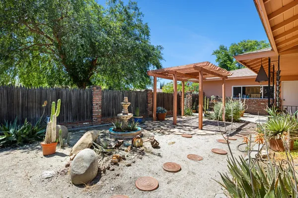 a view of a lounge chair and tables in the patio